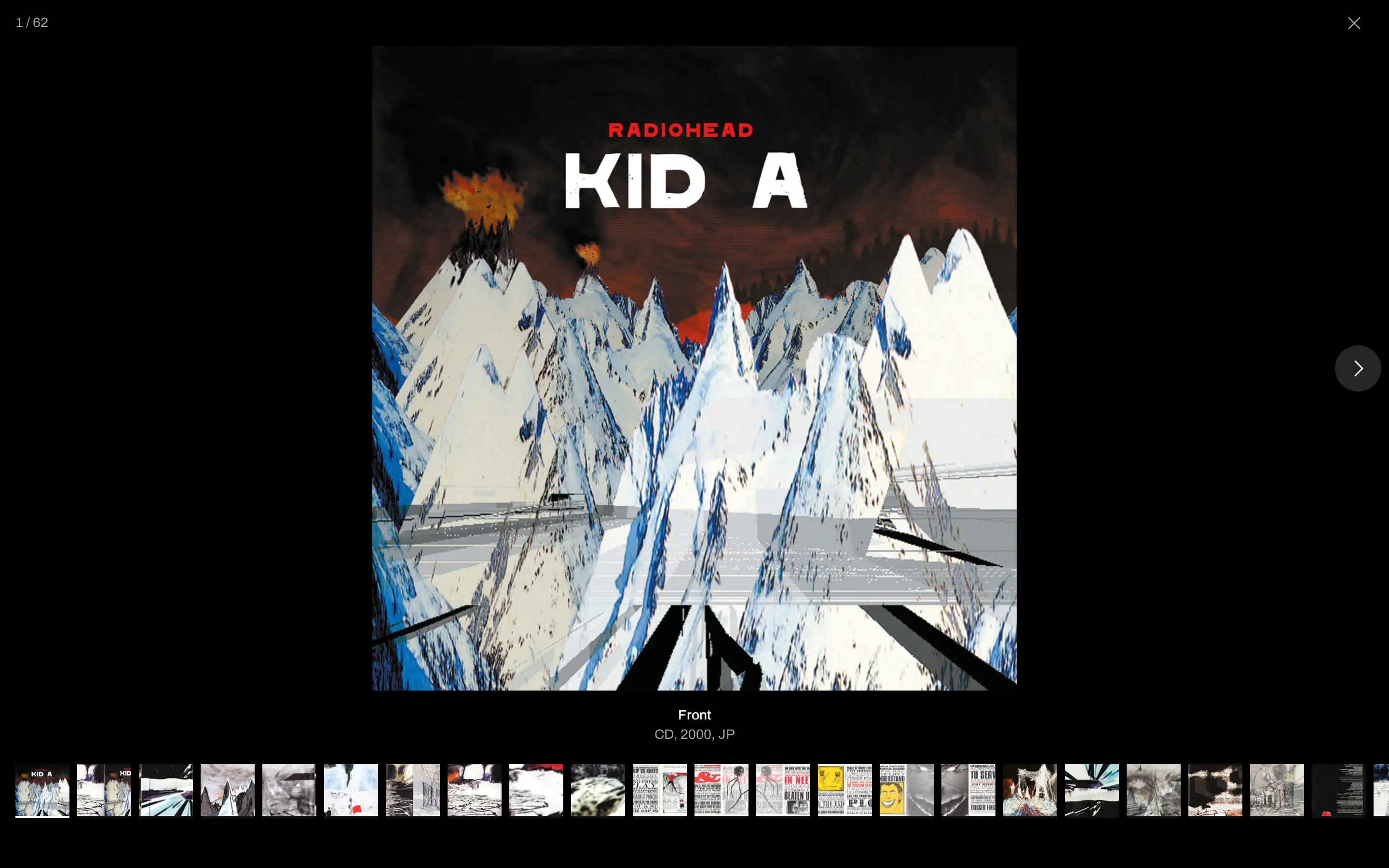 The album image viewer open on the Kid A cover, one of sixty-two scans, with a filmstrip of booklet pages and posters below